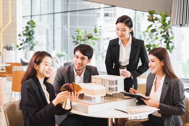 group of young asian business people meeting in office for house real estate residence project - housing project organization meeting real estate imagens e fotografias de stock