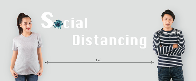Social distancing concept. young Asian man and woman standing with distancing  to protect infection from Coronavirus Covid-19