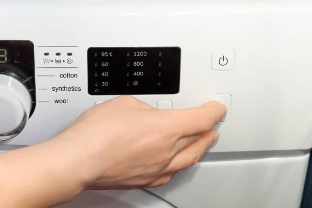 istock cleaning clothes in the washing machine at home 1215535877