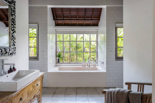 istock Cozy bright bathroom interior with built bathtub 1215538344