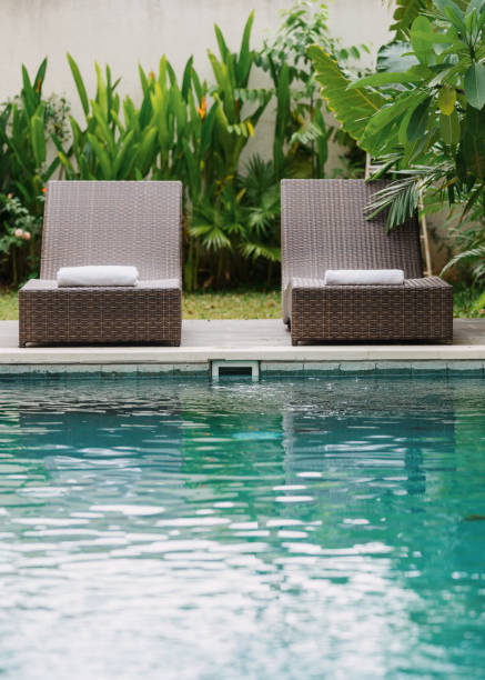 istock Swimming pool with lounge chair outdoors at sunny day 1215538363