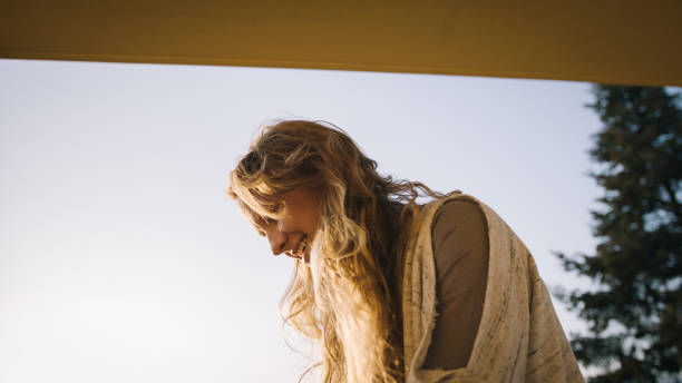 istock Young woman relaxes on terrace 1215538407