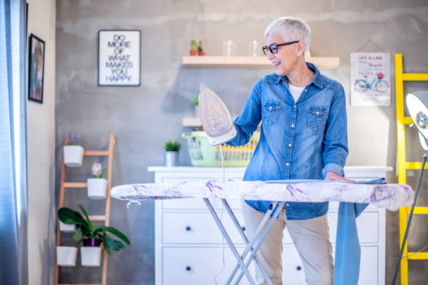 istock Beautiful senior woman ironing her clothes. 1215538848