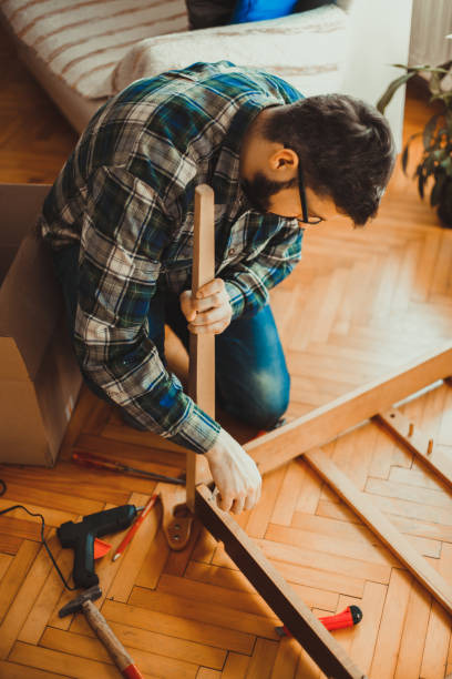 istock Young man in the living room fixing the table 1215539592