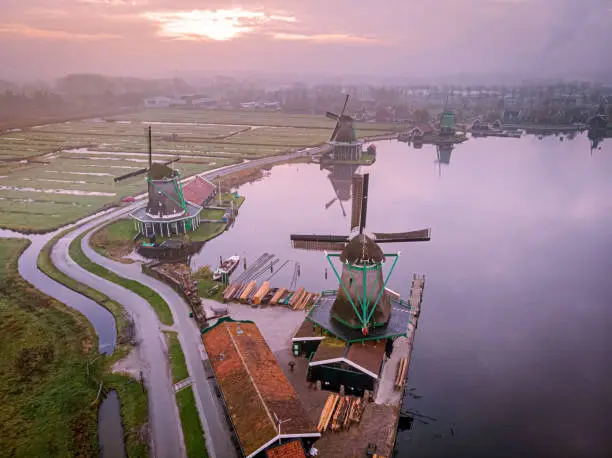 Photo of Zaanse Schans Netherlands a Dutch windmill village during sunset whit wooden house holland