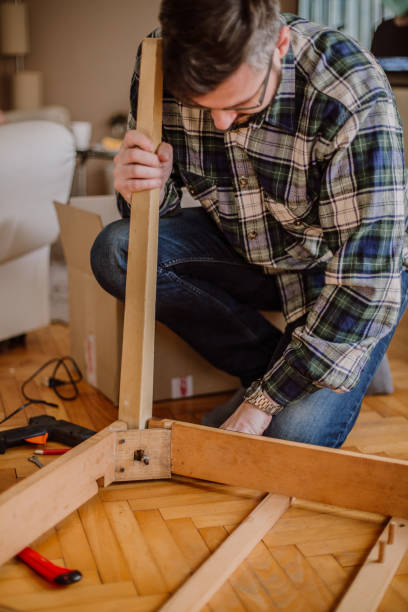 istock Young man in the living room fixing the table 1215539902