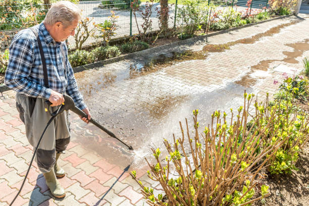 istock Active Senior Man Using High Pressure Washer to Clean the Entrance 1215541514