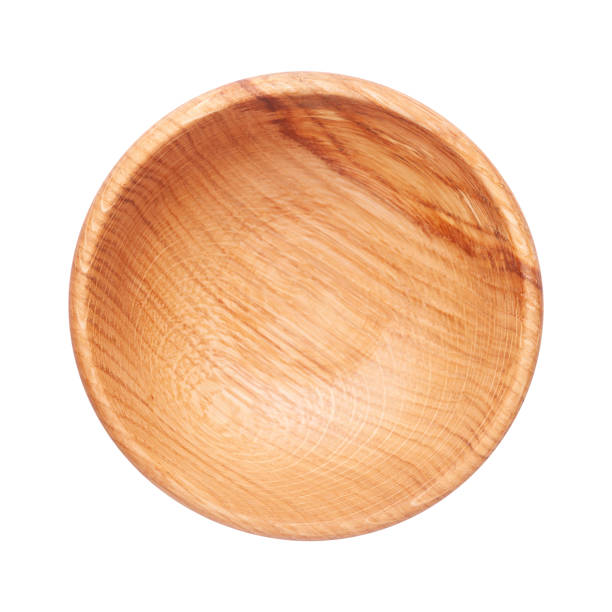 istock Wooden plate isolated on white background. Top view of empty dishware with space for text. Handcrafted cooking utensil 1215541675