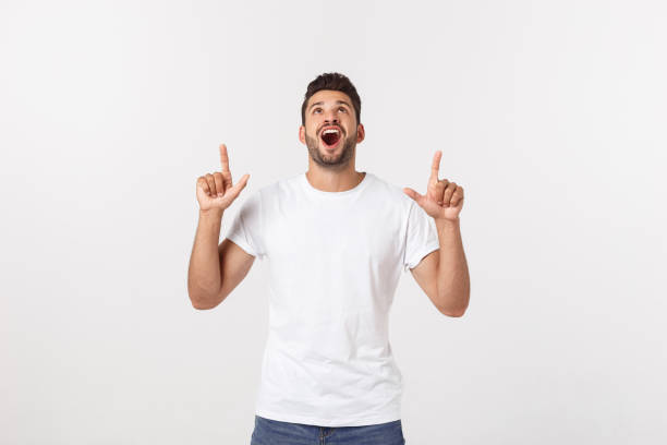 istock Man pointing showing copy space isolated on white background. Casual handsome Caucasian young man. 1215542757