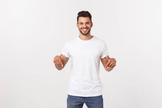 istock Man pointing showing copy space isolated on white background. Casual handsome Caucasian young man. 1215542788