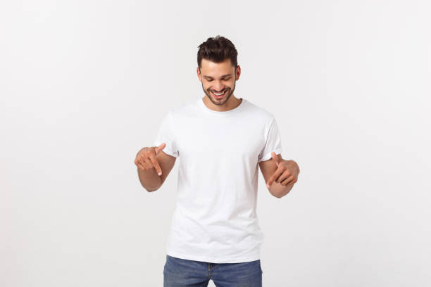 istock Man pointing showing copy space isolated on white background. Casual handsome Caucasian young man. 1215542932