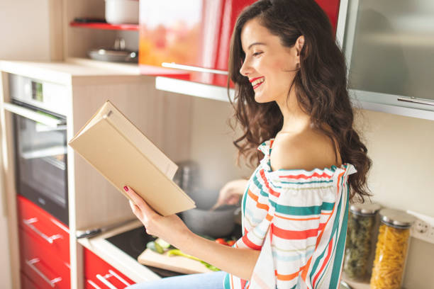 istock Woman preparing food in her red kitchen 1215544524
