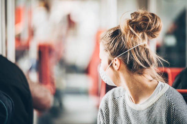 Young woman looks back at empty train car