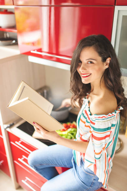 istock Woman preparing food in her red kitchen 1215544748