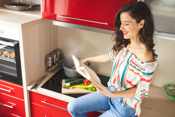 istock Woman preparing food in her red kitchen 1215544867