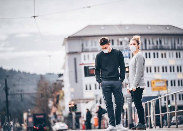 istock Young couple wait for train to arrive in ghost town 1215545020