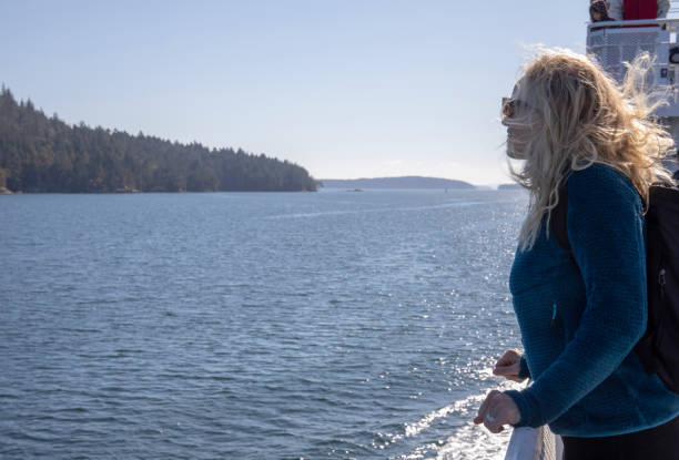 istock Woman relaxes on ferry deck 1215545059