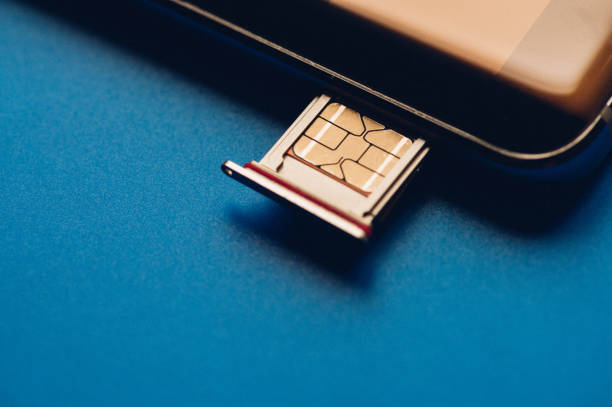 istock Smart phone and sim card on blue background 1215545184
