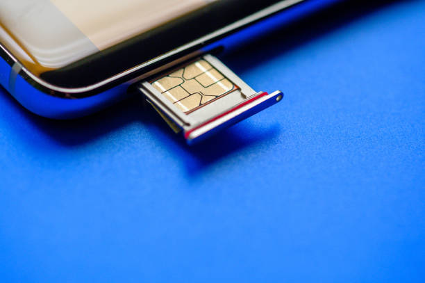 istock Smart phone and sim card on blue background 1215545195