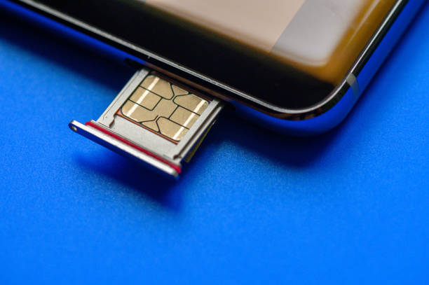 Smart phone and sim card on blue background Image of Smart phone and sim card on blue background. Broadband 5G mobile communication technology concept. sim cards stock pictures, royalty-free photos & images
