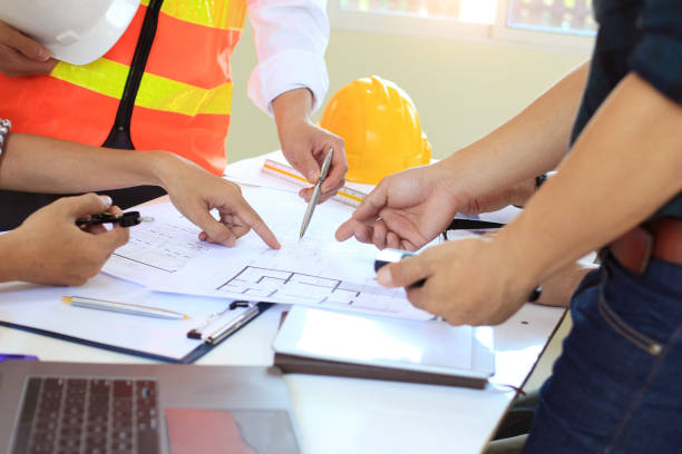 istock Team Engineers are writing solar panel for home construction designs to bring them to prospective customers.concept 1215548458