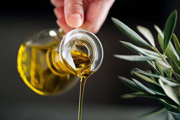 Bottle of Extra virgin olive oil pouring stock photo