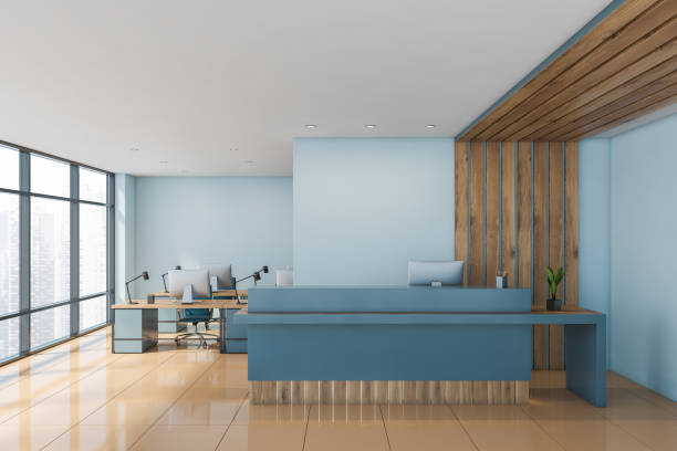 istock Blue and wood reception desk in open space office 1215549576