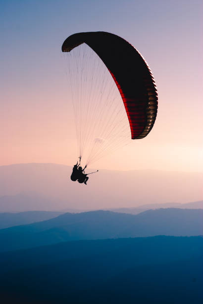 istock Paraglide silhouette in a sky 1215552733