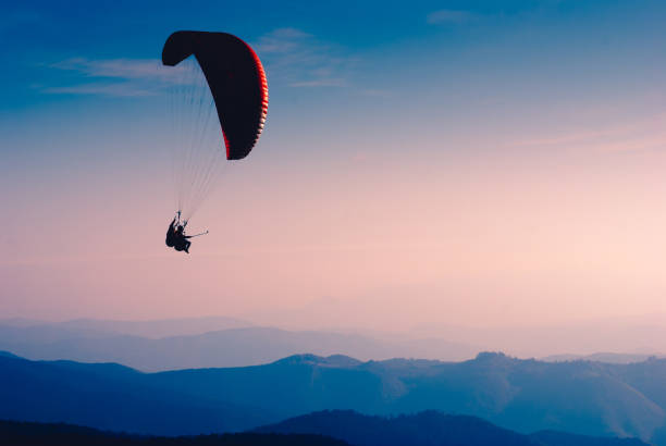istock Paraglide silhouette in a light of sunrise 1215552788