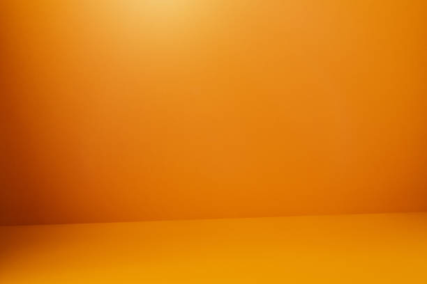 istock Orange colored wall and floor with a soft shadow at the corner 1215552793