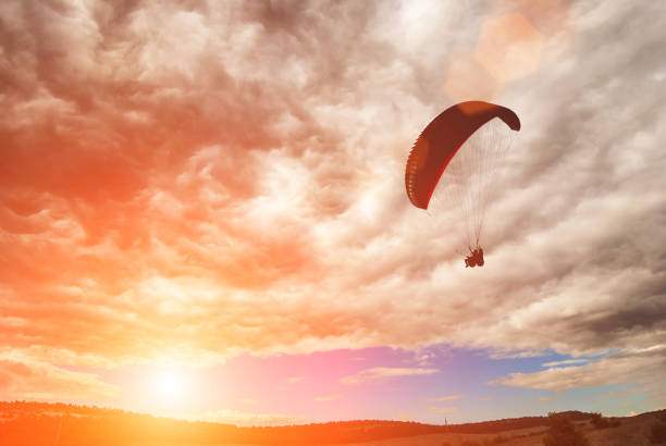 istock Flying paraglide over the valley in a sky with stormy clouds 1215552812