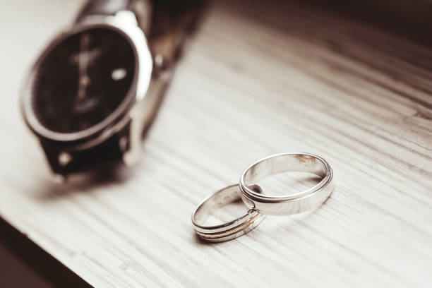 istock Two wedding rings and a watch 1215553181