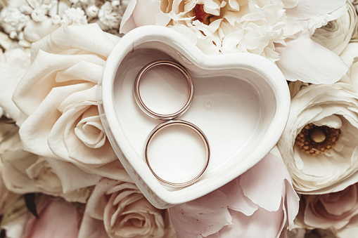Wedding rings in a heart-shaped box.