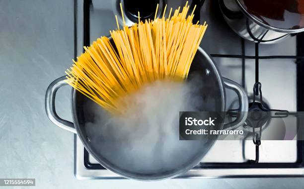 Cooking Raw Spaghetti In The Boiling Water Contained In A Saucepan Stock Photo - Download Image Now