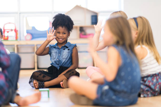 istock Kindergarten Class Asking Questions During Circle Time stock photo 1215556559