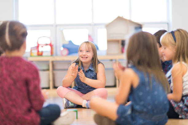 istock Kindergarten Class Singing and Clapping During Circle Time stock photo 1215556561