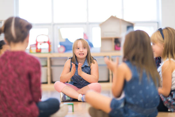 istock Kindergarten Class Singing and Clapping During Circle Time stock photo 1215556586