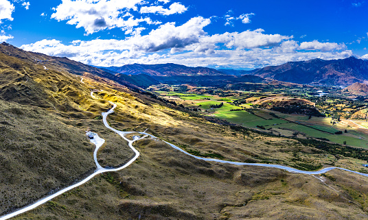 Panorama photo of The Coronet Peak and Skippers Road Entrance and Arrowtown in the background. Otago, New Zealand