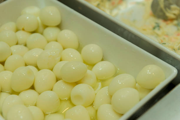 istock Closeup of quail eggs cooked in white ceramic bowl. 1215560428