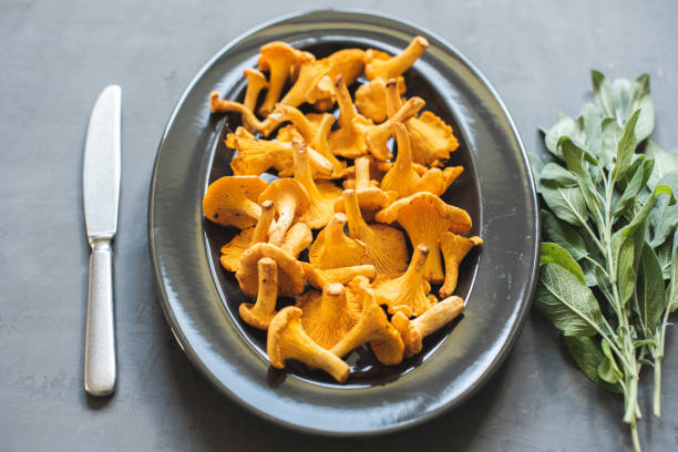 istock Fresh red chanterelle mushrooms on gray concrete background 1215561574