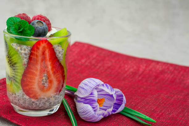 quinoa chia seeds dessert with almonds milk strawberry raspberry blueberry kiwi fresh mint napkin