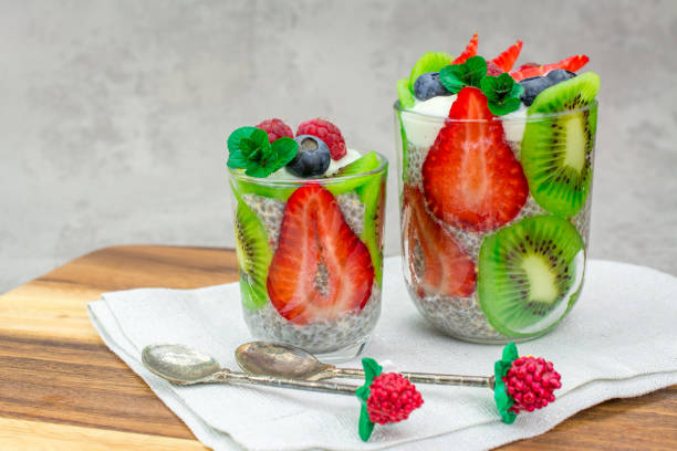 quinoa chia seeds dessert with almonds milk strawberry raspberry blueberry kiwi fresh mint napkin