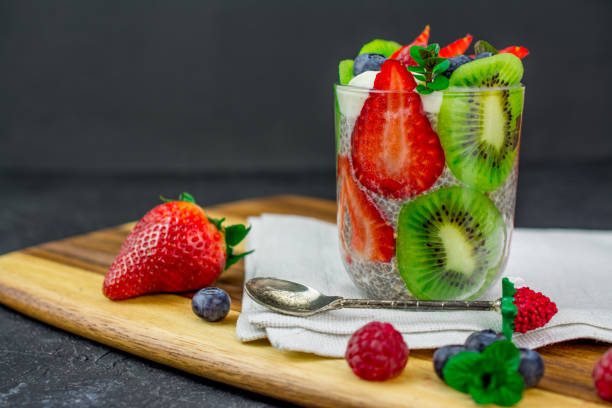 quinoa chia seeds dessert with almonds milk strawberry raspberry blueberry kiwi fresh mint napkin