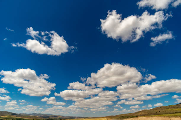 istock Blue clear sky with clouds and field 1215567076