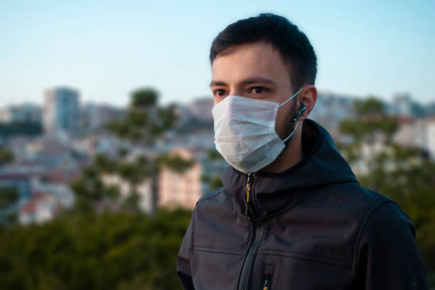 istock Isolated young man wearing mask looking towards 1215567289