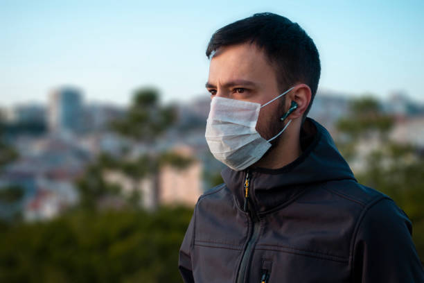 istock Isolated young man wearing mask looking towards in concern 1215567360