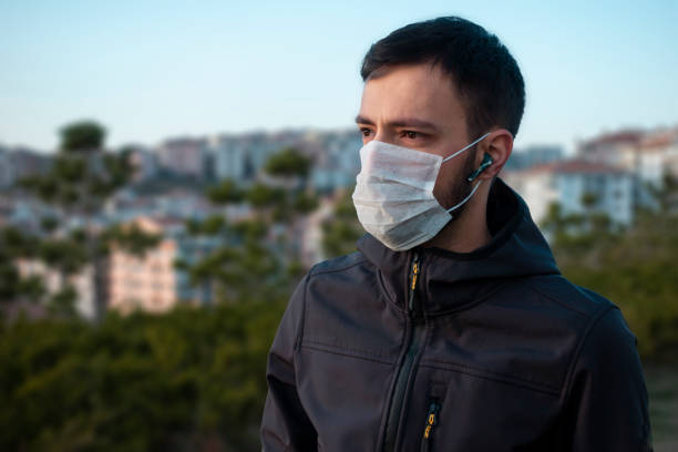 istock Isolated young man wearing mask looking towards in concern 1215567381