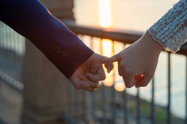 istock Women and men hold hands in the evening 1215569911