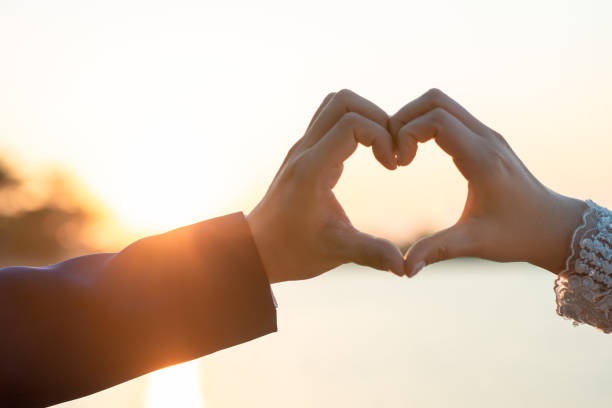 istock Women and men hold hands in the evening 1215569912