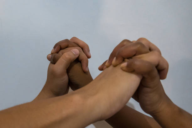 istock Two Hands together generate union on a white background. 1215569944